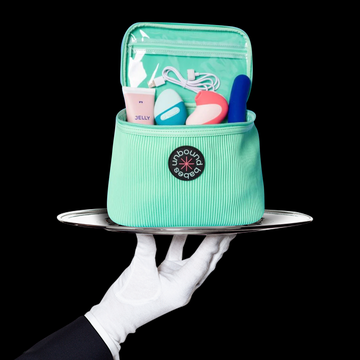 Sex Toy Storage sex toy storage case displayed on a silver platter held by a white gloved hand